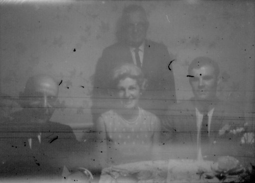 Leon Peters seated at a table with an unidentified woman and two unidentified men