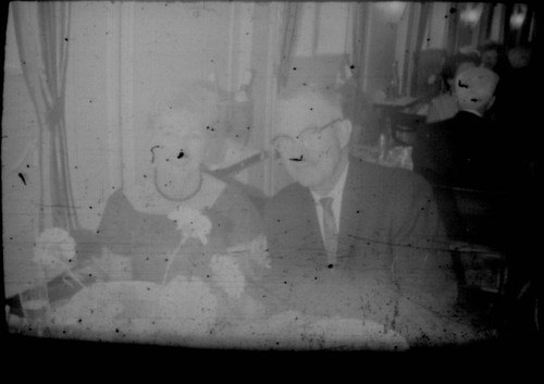 Unidentified man and woman seated at a table