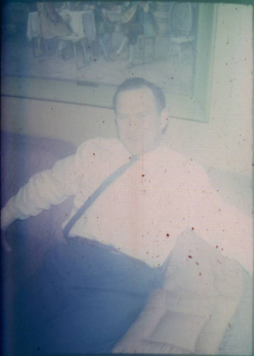 Unidentified man seated on couch