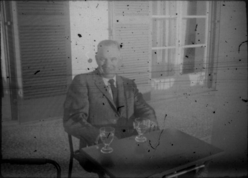 Unidentified man seated at an outdoor cafe