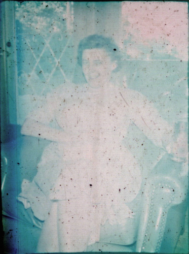 Unidentified woman seated in an armchair