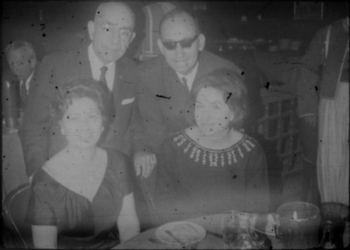 Leon and Alice Peters with unidentified man and woman in restaurant