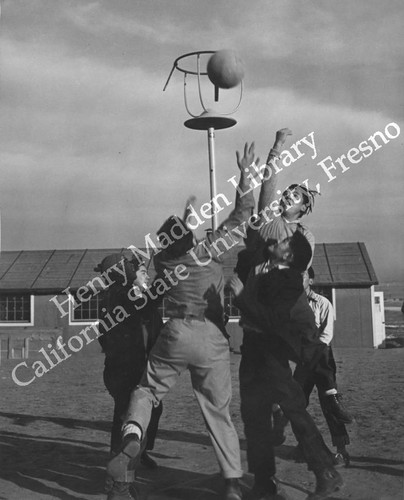 Boys playing basketball at Granada Relocation Center