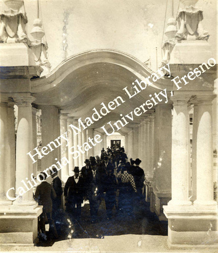 Visitors walking through colonnade between Liberal Arts and Mines and Mining Buildings