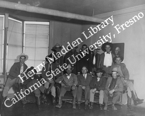 Group photo of men in western hats and boots