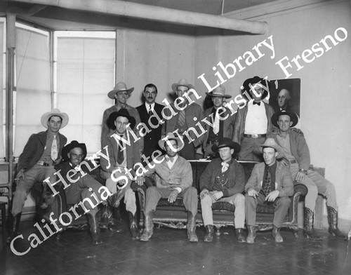 Group photo of men in western hats and boots