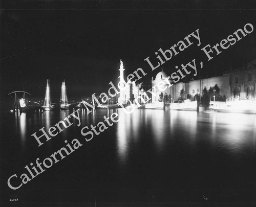 Column of Progress and adjacent buildings at night