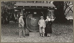 [Alfred Fuhrman posing with man and woman near redwood aging display at Muir Woods]