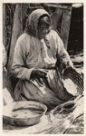 [American Indian woman making a basket]