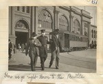 [Policeman with flu mask leading two men away from the Ferry Building]