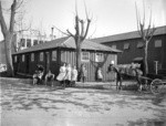 [Children posing before refugee bath house. Unidentified location]