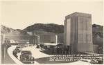 Highway on crest of Boulder Dam, with elevator tower where visitors are conducted by guides to Powerhouse