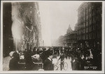 [Crowd gathered in Market St. to watch fire in distance. Looking northeast from near Geary, Kearny and Thirds Sts. Palace Hotel, right]