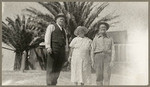 [Alfred Fuhrman standing next to man and woman with palm trees behind them]