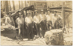 [Group portrait of men in work area]