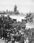 [Crowd gathered for unidentified event. At Market St. and Van Ness Ave. City Hall in background]