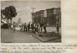 [Soldier standing guard over workers]