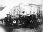 [Fire engine in street, unidentified location. Establishment of John W. King, Grocer, background]