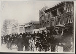 [Market Street scene of procession of soldiers. Earthquake-damaged building at right]