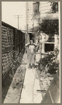 [Woman on side yard of San Francisco house]