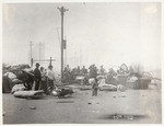 [Street scene of refugees with belongings. Unidentified location]