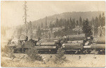 [S.L.R.R. locomotive hauling load of logs]