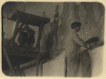 Maynard Dixon working on mural in State Library, 1928 (2 views)