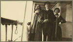 [Two women posing with ship officer on the SS Admiral Farragut]