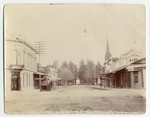 02 Main Street, Bank corners, P. office, M.E. Church and park, Mrs. Hare Photo