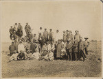 [Group portrait of men in field]