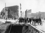 [Men posing at opening in ground. From Turk and Mason Sts. (?) at Market. Native Sons of the Golden West statue, center; Flood Building, Call Building and Emporium department store in background center]