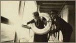 [Woman in life preserver posing with ship officer, SS Admiral Farragut]