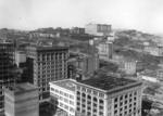 [Cityscape from above circa Kearny and Post Sts. looking northwest toward Nob Hill. Fairmont Hotel in distance, center]