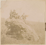 [Men posed on rock]