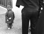 [Child looking at police officer]