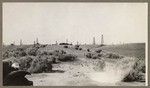 [Oil field with shrubs in foreground]