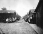 [Franklin Square refugee camp? Children posing along rows of cottages]