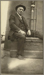 [Alfred Fuhrman sitting on deck next to ship's funnel, SS Admiral Farragut]