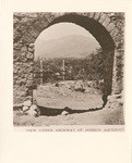 View under archway of [Santa Barbara] Mission aqueduct