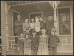 [Family posed on a porch]