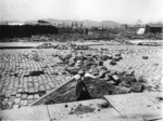 [Subsidence and fissures along street. Unidentified location. (South of Market St.?) Twin Peaks in distance, left center]