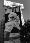 [Painted billboard of Angelyne on building]