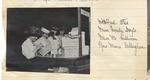 Four women at a table with a number of boxes.