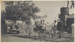 Family posing in cart in Goleta, 2 views