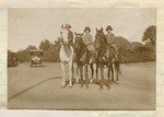 [Three children riding horses]