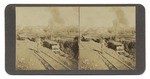 [View of steam shovel clearing a pit next to railroad tracks]