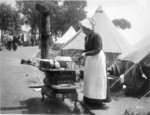 [Woman cooking at street kitchen. Unidentified refugee camp]