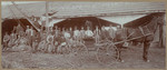 [Group portrait of men at warehouse]