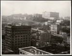 [Cityscape from above circa Kearny and Post Sts. looking northwest toward Nob Hill. Fairmont Hotel in distance, right center]