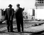 [Two elderly men at construction site]